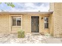 Charming brick home featuring a secure black metal front door and well-maintained front yard at 2515 S Maple Ave # 103, Tempe, AZ 85282