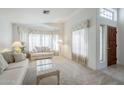 Cozy living room featuring neutral carpet, soft lighting, and comfortable seating at 2629 E Verbena Dr, Phoenix, AZ 85048