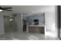 Bright kitchen boasts stainless steel appliances, stylish island, and updated cabinets, perfect for modern living at 29462 N 126Th Ln, Peoria, AZ 85383