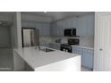 Well-equipped kitchen showcases stainless steel appliances, light cabinetry, and quartz countertops at 29462 N 126Th Ln, Peoria, AZ 85383