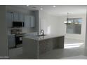 Sunlit kitchen featuring sleek countertops, modern appliances, and an open layout, ideal for entertaining at 29462 N 126Th Ln, Peoria, AZ 85383