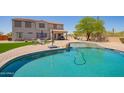 Large backyard features a pool, patio area, well-maintained lawn, and desert landscaping for outdoor living at 32525 N 41St Way, Cave Creek, AZ 85331