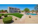 Expansive backyard featuring a pool, lush lawn, and patio, ideal for outdoor entertaining at 32525 N 41St Way, Cave Creek, AZ 85331