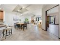 Open-concept living area features a fireplace, dining space, and access to an outdoor patio at 36601 N Mule Train Rd # 45B, Carefree, AZ 85377