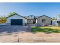 Charming home with a paved driveway, brick accents, and a well-manicured front yard at 3834 E Clarendon Ave, Phoenix, AZ 85018