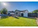 Lush green lawn and modern brick accents enhance this home's curb appeal at 3834 E Clarendon Ave, Phoenix, AZ 85018