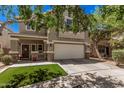 Two-story home with a two-car garage, landscaped front yard with decorative stone and a covered front porch at 4117 E Baylor Ln, Gilbert, AZ 85296