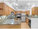 Spacious kitchen features tile backsplash, stainless steel appliances, and plenty of counter space at 4200 N Miller Rd # 112, Scottsdale, AZ 85251