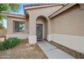 Inviting front entrance with an arched doorway and a charming wreath, set in a neutral stucco home at 4466 S Brice --, Mesa, AZ 85212
