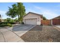 View of single-story home with neutral stucco and a well-kept yard with easy access to the side yard at 4466 S Brice --, Mesa, AZ 85212