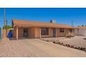Single-story home showcasing desert landscaping, covered parking, and a brick facade at 4545 N 49Th Ave, Phoenix, AZ 85031