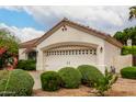 Exterior shot of a house with a two-car garage and decorative landscaping at 4738 N Greenview W Cir, Litchfield Park, AZ 85340