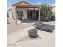Relaxing backyard with covered patio, lounge chairs, and a fire pit at 4765 E Charleston Ave, Phoenix, AZ 85032