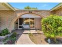 Inviting front porch with a brick archway, a cozy bench, and attractive landscaping at 504 N Emerson --, Mesa, AZ 85201
