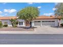 Charming one-story home featuring a clay tile roof, desert landscaping, and a two car garage at 5322 W Wethersfield Dr, Glendale, AZ 85304
