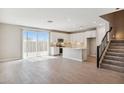 Bright open-concept kitchen featuring white cabinets, an island, and a sliding glass door at 5859 E Covey Ln, Phoenix, AZ 85054