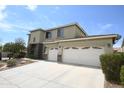 Inviting two-story home showcasing a spacious driveway and a three-car garage with stone accents at 6619 W Cordia Ln, Phoenix, AZ 85083