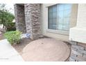 Charming front entryway featuring brick columns and a round inlaid-brick patio area at 6619 W Cordia Ln, Phoenix, AZ 85083