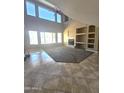 Bright living room featuring a fireplace, tile and carpet flooring, and large windows for natural light at 6619 W Cordia Ln, Phoenix, AZ 85083