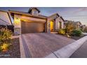 Beautiful home with a brick driveway, well-kept landscaping, and stone detailing at 6929 E Quill St, Mesa, AZ 85207