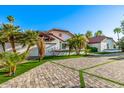 Spacious property with an expansive driveway and lush tropical landscaping at 6941 W Voltaire Ave, Peoria, AZ 85381