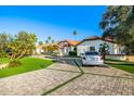 Stately home with a long, inviting driveway and well manicured lawn at 6941 W Voltaire Ave, Peoria, AZ 85381