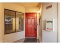 Inviting condo front door with red paint, dark hardware, and covered porch at 750 E Northern Ave # 2045, Phoenix, AZ 85020