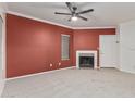 Spacious living room featuring a fireplace, neutral carpet, and ceiling fan at 750 E Northern Ave # 2045, Phoenix, AZ 85020