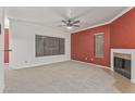 Bright living room with neutral carpet, ceiling fan, and fireplace at 750 E Northern Ave # 2045, Phoenix, AZ 85020