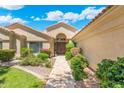 Inviting home exterior boasting manicured landscaping and a beautiful walkway to the arched double-door entrance at 7734 E Monica Dr, Scottsdale, AZ 85255