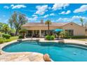 Backyard pool with lush landscaping, a covered patio, and comfortable seating areas for outdoor relaxation at 7734 E Monica Dr, Scottsdale, AZ 85255