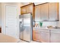 Stainless steel refrigerator and modern cabinets complement this beautiful kitchen space at 7854 W Tether Trl, Peoria, AZ 85383