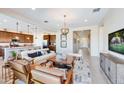Open-concept living room with modern furniture, a decorative rug, and hardwood floors at 7854 W Tether Trl, Peoria, AZ 85383