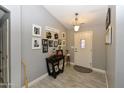 Welcoming entryway with tile flooring, gray walls adorned with pictures, and stylish decorations at 7916 E Naranja Ave, Mesa, AZ 85209
