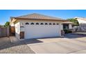 A spacious two-car garage with a white door and a well-kept driveway, offering ample parking space at 7916 E Naranja Ave, Mesa, AZ 85209