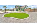 Manicured lawn with unique design and gravel adding curb appeal to this well-maintained home at 8871 W Maryland Ave, Glendale, AZ 85305