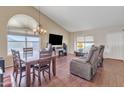 Inviting living room featuring wood floors, vaulted ceilings and an open floor plan, perfect for relaxation and entertaining at 8871 W Maryland Ave, Glendale, AZ 85305