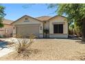 Well-maintained single-story house featuring low-maintenance desert landscaping and a neutral color palette at 9343 W Harmony Ln, Peoria, AZ 85382