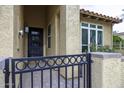 Up-close look at the gated front entrance with a stylish front door and desert-style landscaping at 943 E Kortsen Rd # 2, Casa Grande, AZ 85122
