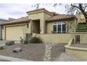Charming tan home with a tile roof, desert landscaping, and a welcoming front entrance at 943 E Kortsen Rd # 2, Casa Grande, AZ 85122