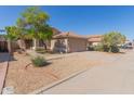 Single Gathering home featuring a two-car garage, red tile roof, and low maintenance landscaping at 1058 W Swan Dr, Chandler, AZ 85286
