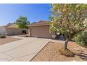 Charming single Gathering home with a two-car garage, tile roof, and desert landscaping at 1058 W Swan Dr, Chandler, AZ 85286