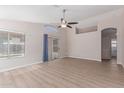 Bright living room featuring wood flooring, a ceiling fan, and sliding glass doors at 1058 W Swan Dr, Chandler, AZ 85286