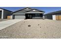 Charming single-story home featuring a two car garage and xeriscape front yard at 11796 N Vanero Ct, Maricopa, AZ 85139
