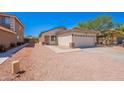 Inviting single-story home featuring a two-car garage, low maintenance yard, and desert landscaping at 11805 W Sunnyside Dr, El Mirage, AZ 85335