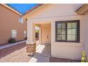 Inviting front entrance showcasing a covered porch, stone accents, and well-kept landscaping at 11805 W Sunnyside Dr, El Mirage, AZ 85335