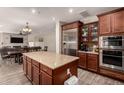 Spacious kitchen features a large island, stainless steel appliances, and custom cabinetry, perfect for entertaining at 1217 W Fever Tree Ave, San Tan Valley, AZ 85140