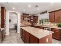This well-lit kitchen boasts granite countertops, custom cabinets, and a large central island at 1217 W Fever Tree Ave, San Tan Valley, AZ 85140