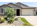 Inviting single-story home featuring a well-manicured front yard and a brick driveway at 1228 W Snowbell Ave, Queen Creek, AZ 85140