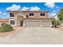 Charming two-story home showcasing a three-car garage and well-maintained front yard at 12748 N 57Th Dr, Glendale, AZ 85304